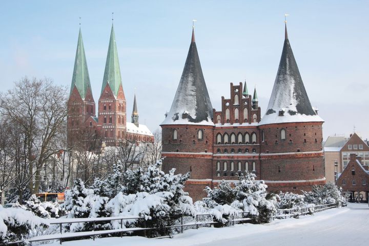 Hansastaden Lübeck, Schleswig-Holstein: Ett snötäckt Holstentor med Marienkirche. FOTO: Norbert Krüger/DZT e.V.