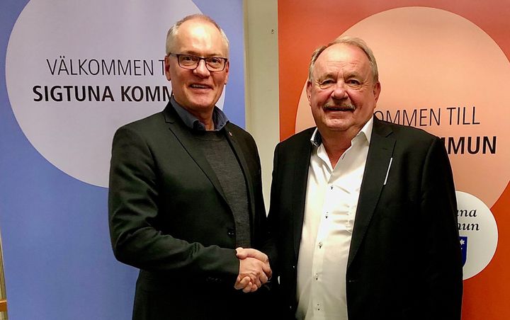 Olov Holst (M), kommunstyrelsens ordförande och Jan Persson, VD och styrelseordförande Kilenkrysset, skakar hand efter att ha kommit överens om villkoren för markförsäljningen - som är den största i Sigtuna kommuns historia.