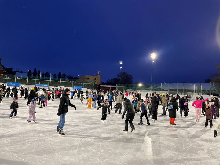 Människor åker skridskor på isbana