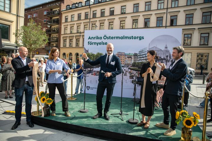 Personer på en scen som klipper ett band.