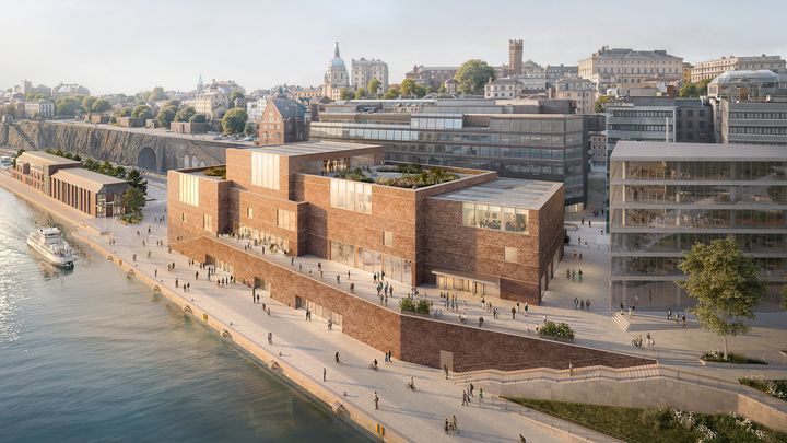 Vy längs strandlinjen mot vattnet. Terrassen framför entrén och de öppna takterrasserna blir nya samlingspunkter i Stockholm med en fantastisk utsikt över Saltsjöns och Mälarens vatten. På sommaren öppnas restaurangen mot terrassen och vattnet. Huset står på en sockel som ansluter till parken och skapar ett nytt gångstråk från Slussen.