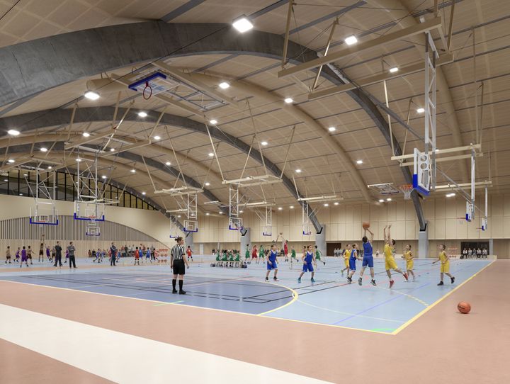 En bild av en idrottshall med basketspelare. Bilden är en visionsbild.