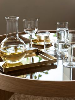Karaff och glas på ett runt bord.