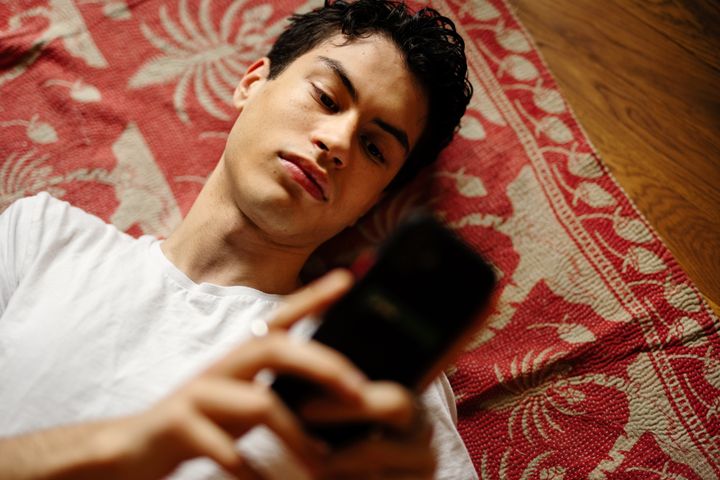 Ungdom scrollar på mobiltelefon.