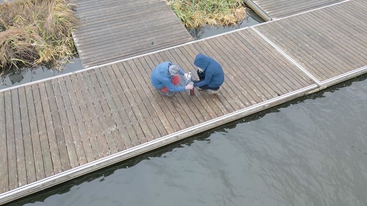 Prof Jens Tränckner and his research assistant Alena Seidenfaden from the University of Rostock take water samples from the Warnow at the jetty of the Olympic rowing centre south of Rostock / EU4Regions