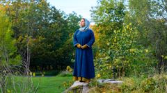 1000-tal: Blå klänning med ett nålhus på bröstet, blå schal om huvudet.