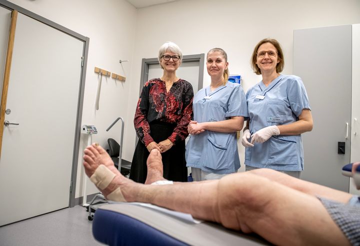 Tre medarbetare vid Venöst centrum med ett ben med åderbråck i förgrunden.