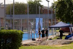 En grupp människor står vid en padelbana utomhus på Lappiskärsberget.