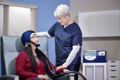 A personalized cap is connected to the DigniCap Delta machine, which cools the patient’s scalp during chemotherapy.