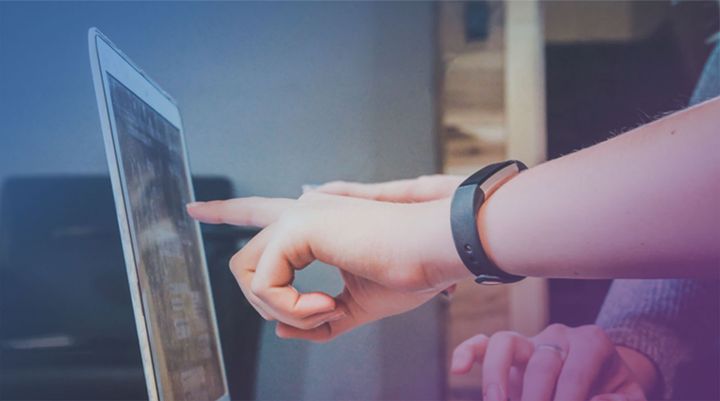 Hand som pekar på en datorskärm.