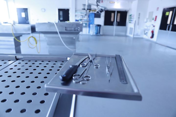 Ett sterilt rum med medicinska instrument på ett metallbord.