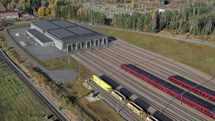 Illustration med översiktsperspektiv av den nya tågdepån i Nässjö, med bangård och tåg.