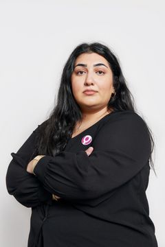Adine Samadi Roks ordförande med armarna i kors iklädd svart skjorta och utsläppt hår