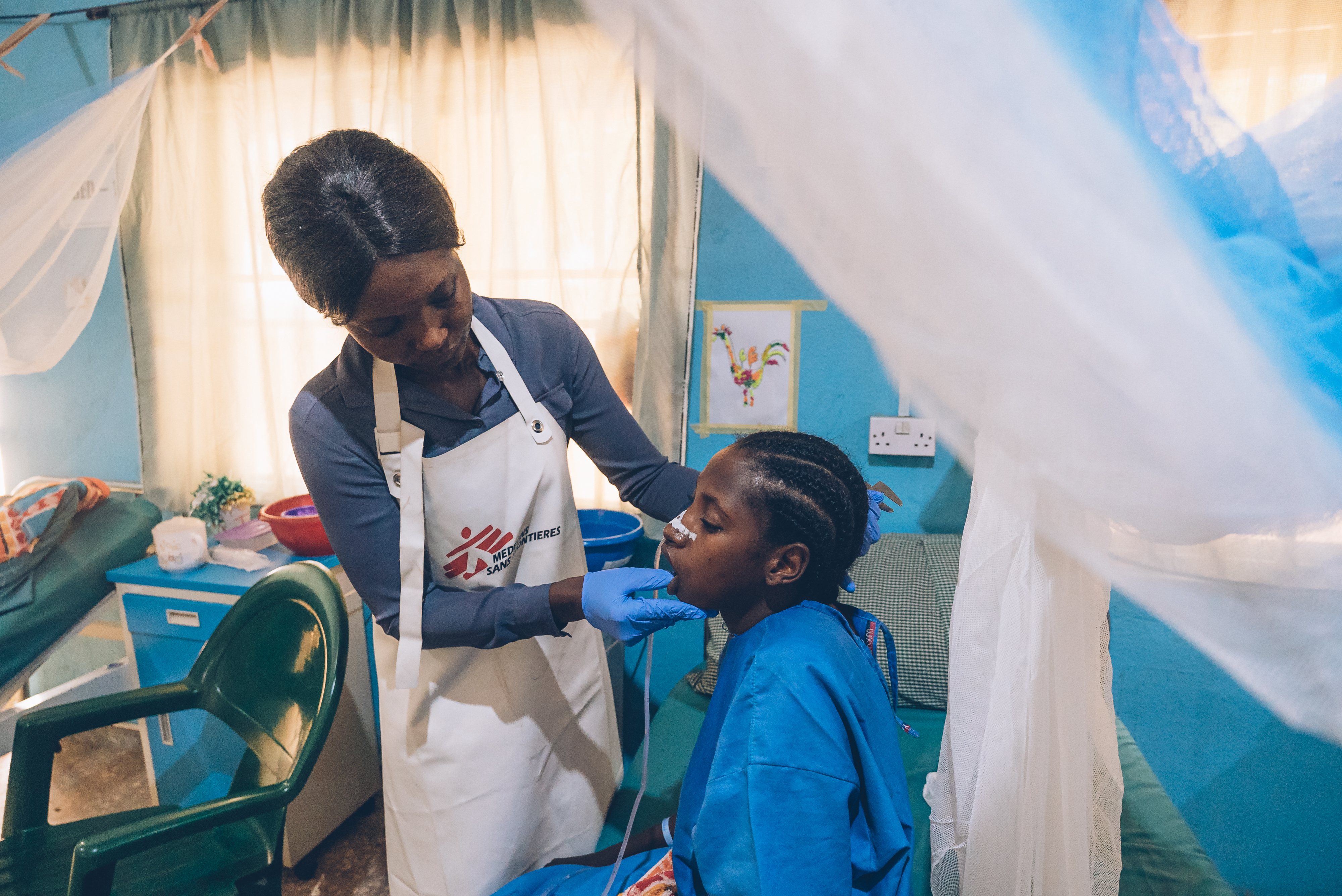 En person undesöker den andra i sjukhusmiljö.