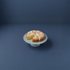 En havtornskaka på ett vitt kakfat, skuren i bitar.