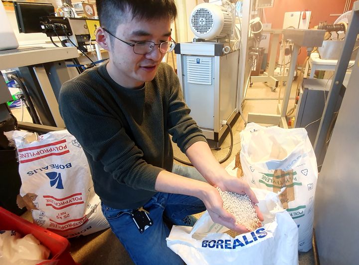 One effect of global warming is faster deterioration of plastics, which in turn results in higher carbon emissions, says Xinfeng Wei, seen here unpacking plastic pellets in the polymer materials lab at KTH Royal Institute of Technology in Stockholm.
