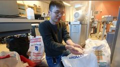 One effect of global warming is faster deterioration of plastics, which in turn results in higher carbon emissions, says researcher Xinfeng Wei, seen here unpacking plastic pellets in the polymer materials lab at KTH Royal Institute of Technology in Stockholm. Photo: David Callahan, CC by 2.0