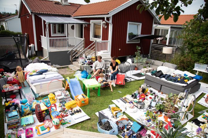 The Hesse family sits among the plastic items emptied from their house near Stockholm.