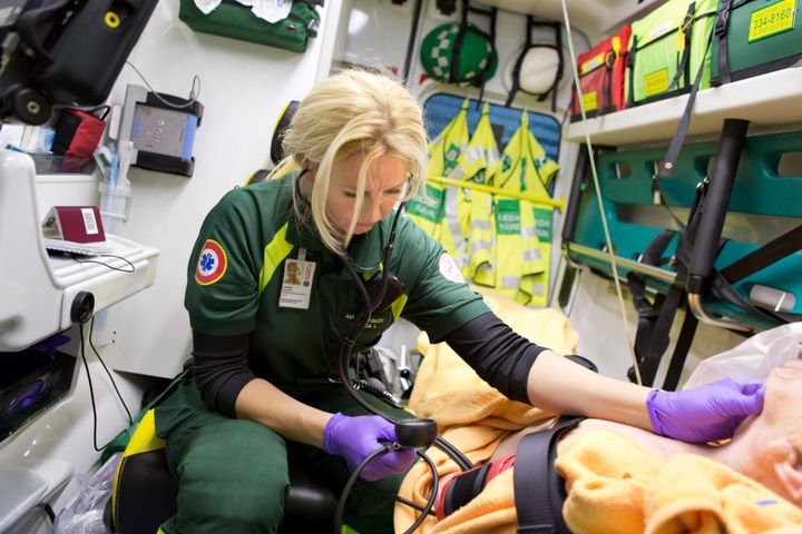 En ambulanssjuksköterska vårdar patient i en ambulans. Fotograf: Ulf Huett