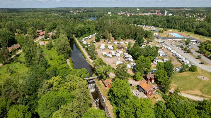 Flygbild över Skantzö bad och camping med campingplatser, grönområden och en kanal.