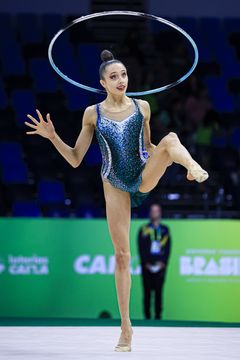 Kvinna som utför en gymnastikövning med ett tunnband på VM i Rio.