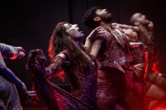Bild på flera dansare i intensiv rörelse på scenen.