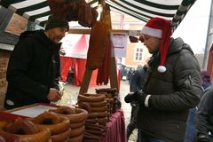 En kund köper korv från en försäljare på Kulturens julmarknad.