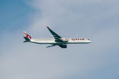 Ett Qatar Airways flygplan i luften mot en blå himmel.