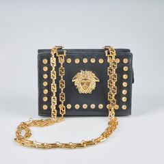 GIANNI VERSACE. Handbag, black leather with yellow metal details.