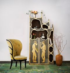 Ambient image featuring Uno Åhrén’s Swedish Grace armchair and Valentin Kielland’s Art Nouveau cabinet, both of which set records at Stockholms Auktionsverk’s auction The Design Sale.