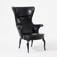 FRITS HENNINGSEN. Wingback armchair, Denmark, 1930s, legs in dark-stained mahogany, upholstered in black leather.