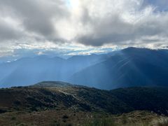 Bergiga gräsmarker i de peruanska Anderna under en molnig himmel.