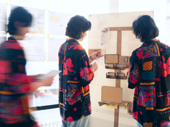 Image of three women in colourful jackets seen from behind