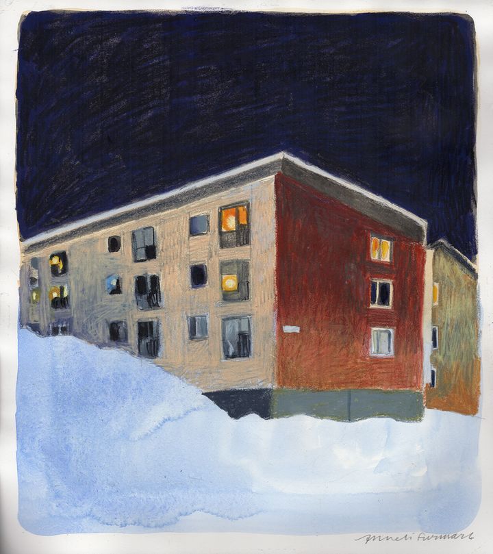 Snow-covered apartment buildings with glowing windows under a dark night sky.