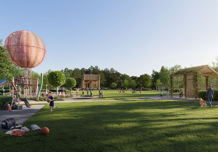 En solig park med människor som promenerar och leker. Det finns träd, en lekplats och en stor gräsmatta.