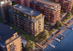 Flygbild över moderna bostadshus och småbåtshamn vid Bryggudden i Karlstad.