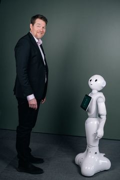 Huddinge Samhällsfastigheters humanoida AI-robot tillsammans med Henrik Örneblad, vd.