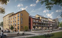 Nybyggda flerbostadshus med gula och röda fasader, cyklister på gatan framför.