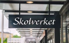 Svart skylt med vit text Skolverkets logotype